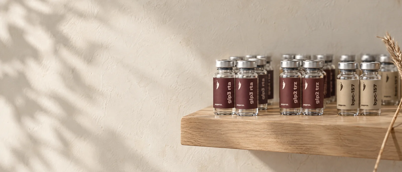 A stocked shelf of pepprzz glp3 rta, glp2 trz and bpc-157 research vials